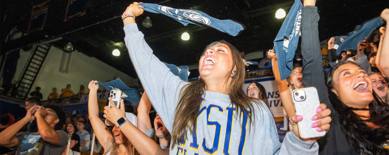 New Kent State University students wave rally towels and cheer during 2024 Convocation.