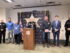 A sheriff speaks at a podium with people around him