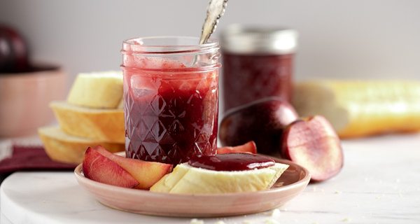 close up of plum butter spread on bread and in mason jar