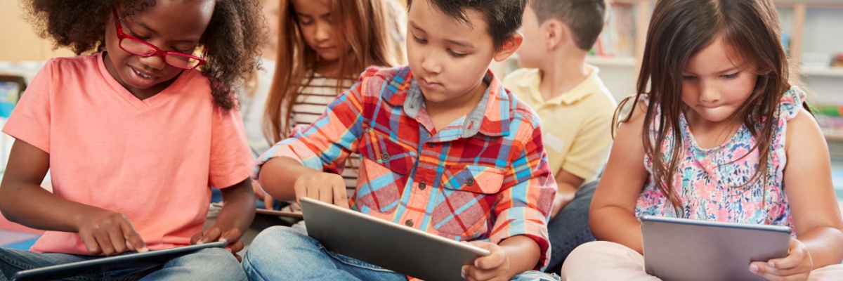 Preschoolers learning on I-pads. 