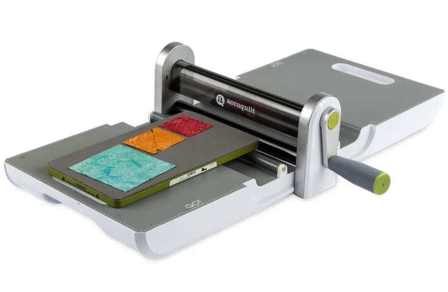 image of AccuQuilt Ready. Set. GO! Ultimate Fabric Cutting System with cutter, Qube die set, strip cutter die, cutting mat, and Qube book