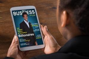 person viewing a business magazine on a tablet