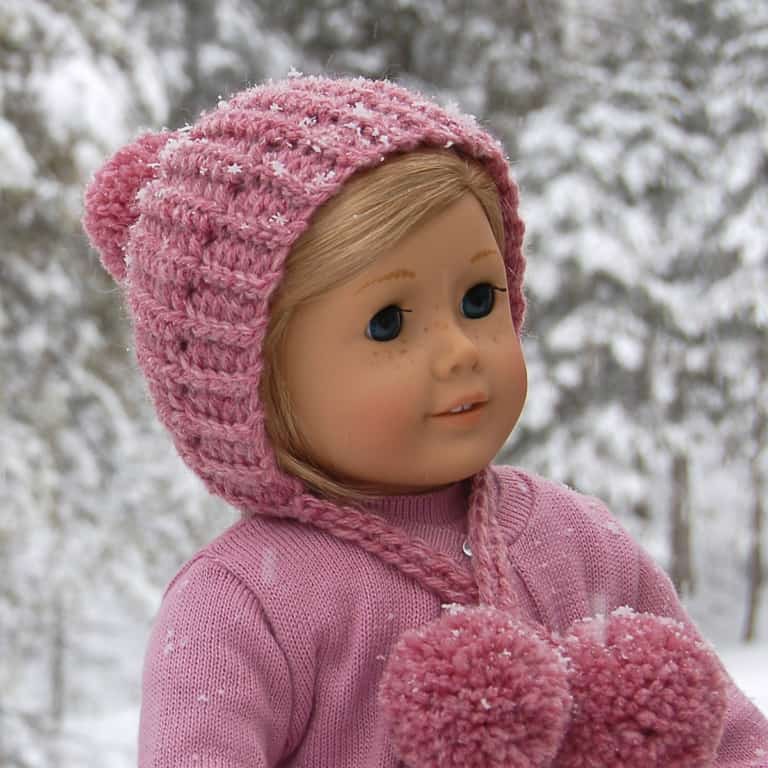 18" doll wearing a pink winter crochet hat.