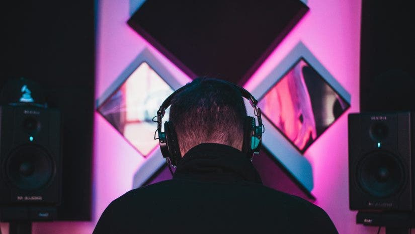 Man wearing black headphones discovers what is mastering in music production