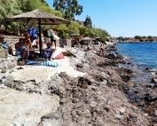 The rocky beach in Perdika on Aegina