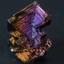 A bismuth crystal on a dark background