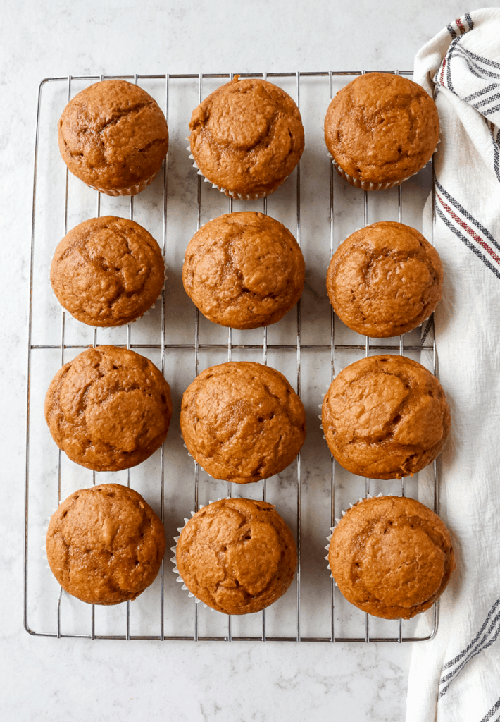 pumpkin cupcakes cooling on a wire rack