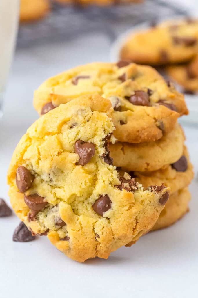 A yellow cake mix cookie on a table with a bite taken out