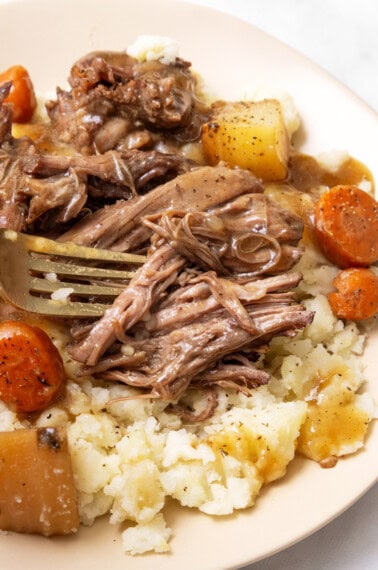 close up image of juicy pot roast with a fork.