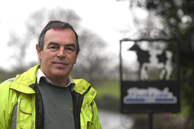 Person stands aside the Beckside Farm sign