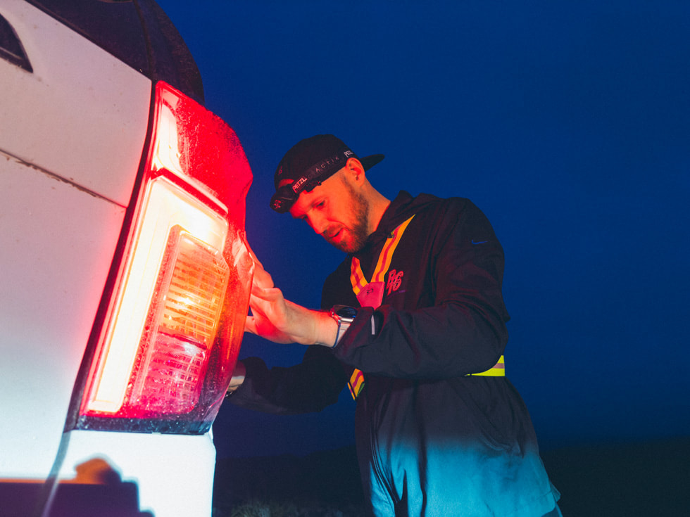 Will Eckman stretching against a car.