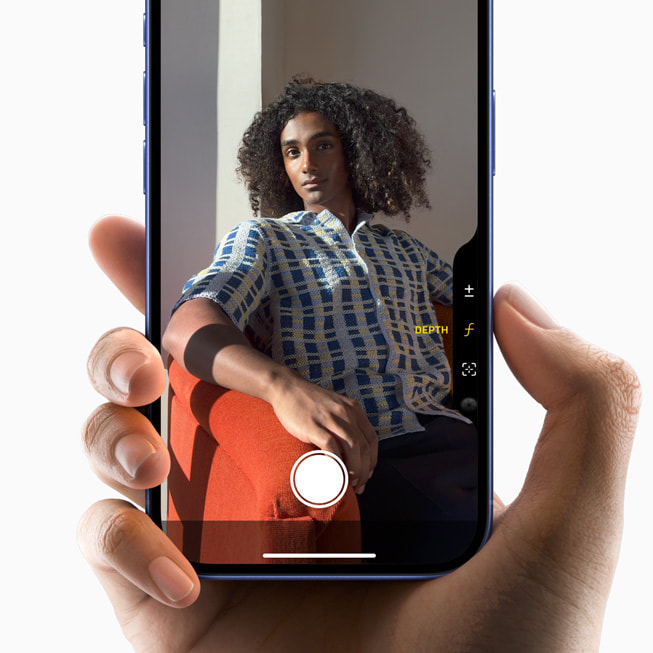 A user adjusts settings while capturing a portrait with iPhone 16.