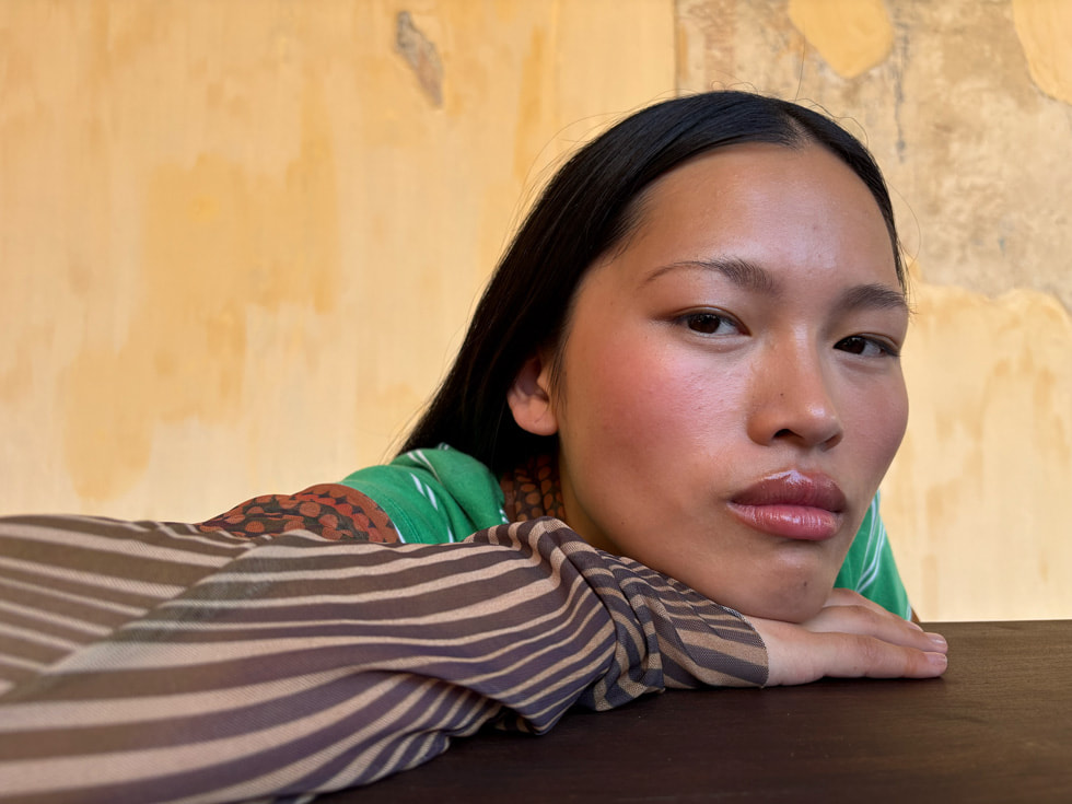 A portrait of a person with their head resting on their hand.