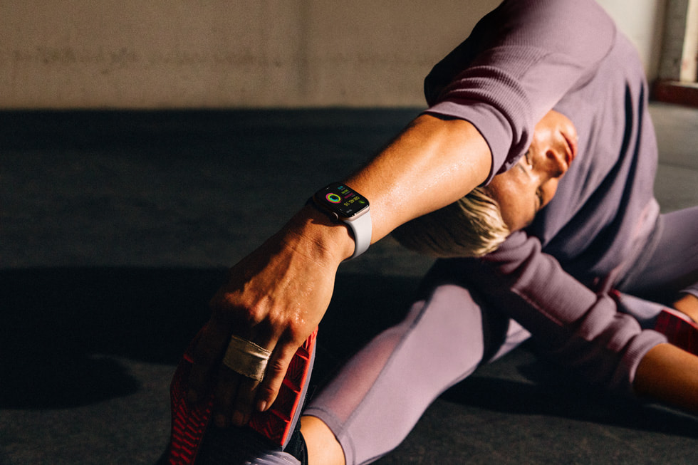 A person wearing Apple Watch Series 10 stretches in a yoga-like pose.