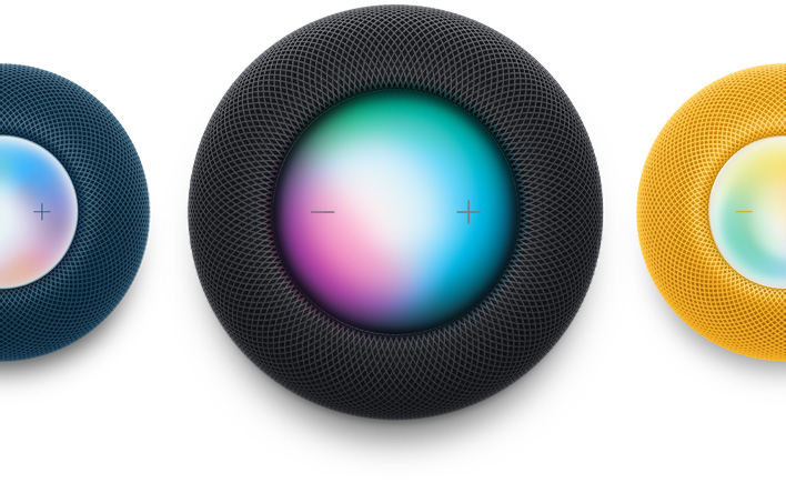 A Blue HomePod mini, a Midnight HomePod and a Yellow HomePod mini shot from the top down. Siri is activated.