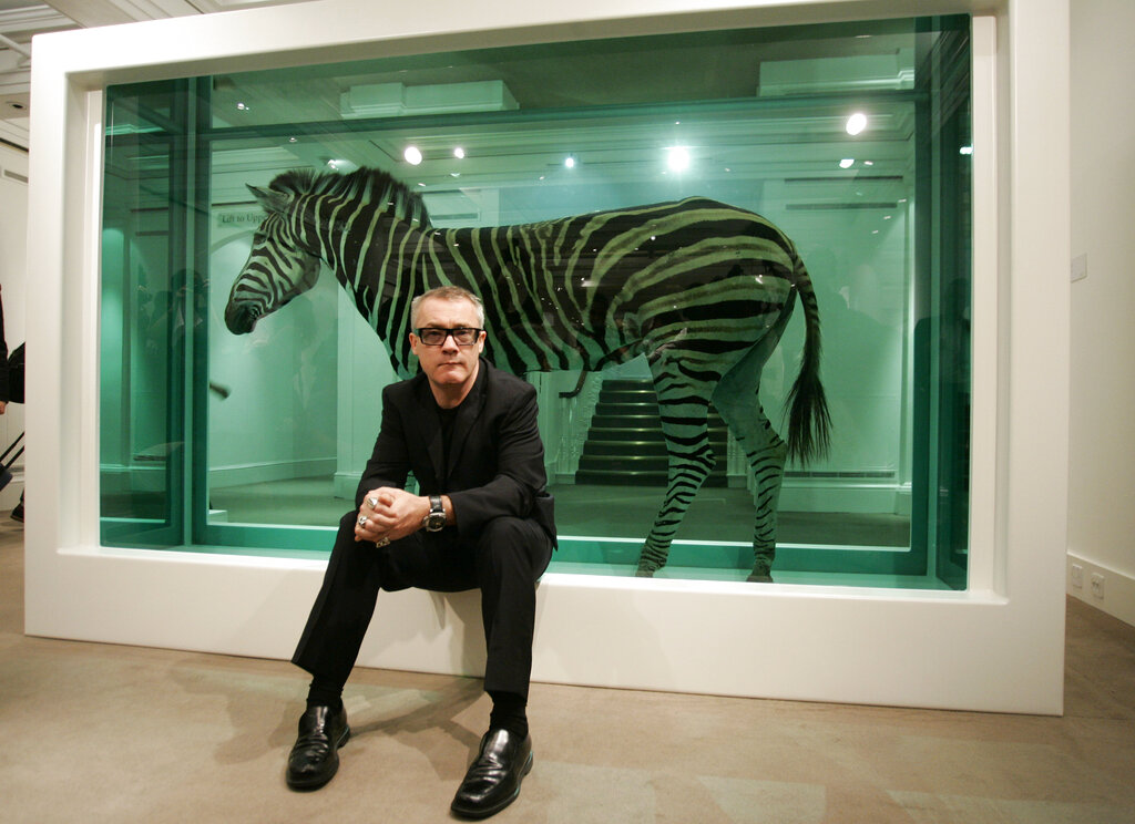 British artist Damien Hirst as he poses with his work 'The Incredible Journey' at an auction house in London, 2008.