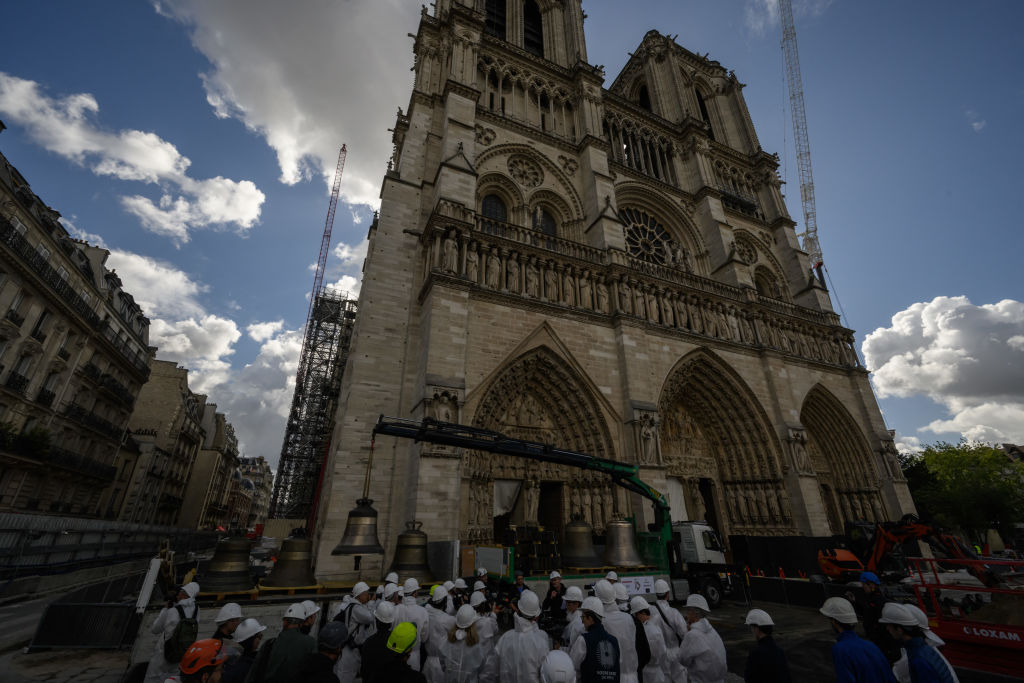 A large stone cathedral against a blue sky with clouds.