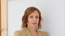 Portrait of a woman standing against a white background.