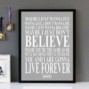 Framed wall art with white text of the song lyrics from Live Forever by Oasis, with a plain grey background.