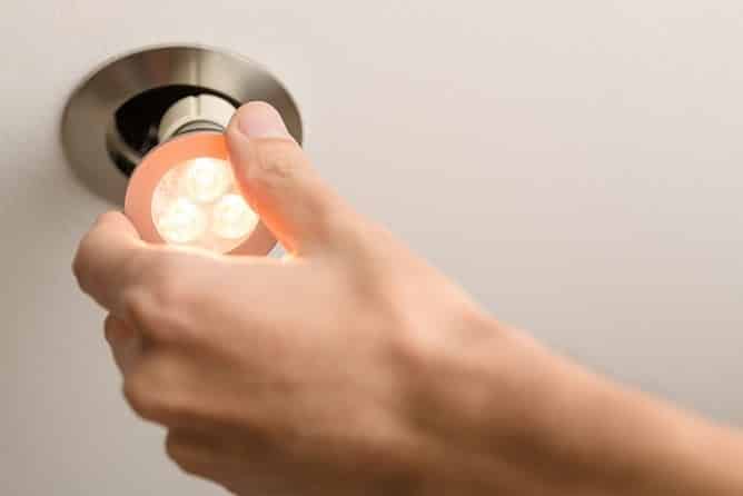 Changing-lightbulb-to-improve-business-safety