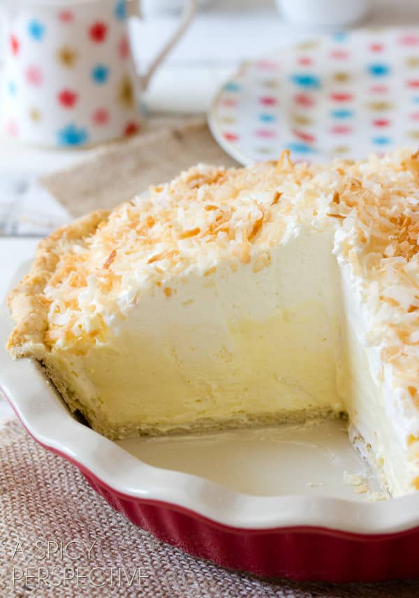 Coconut Pie Recipe with Cream of Coconut - whole pie with sliced cut out showing the inside of the thick cream pie