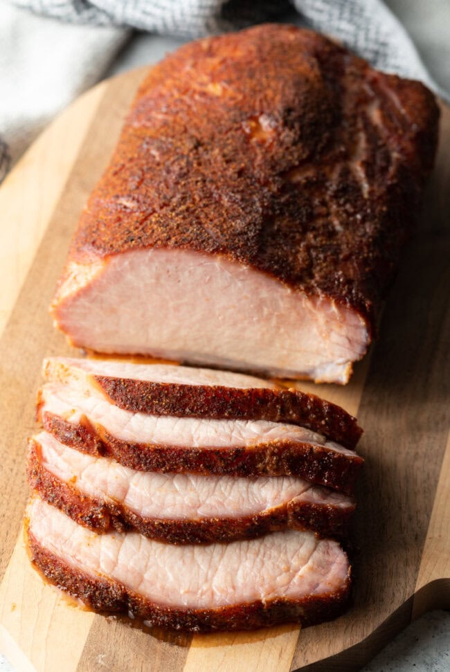 Smoked Pork Loin Rub - carved smoked pork loin on a wood board