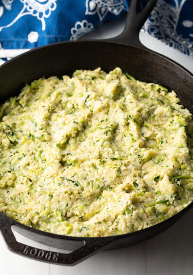 Combination of ingredients smoothed into an even layer in the cast iron skillet.