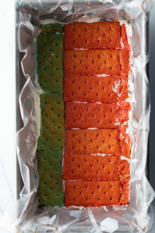 Row of red colored graham cracker pieces in a rectangle bake pan.