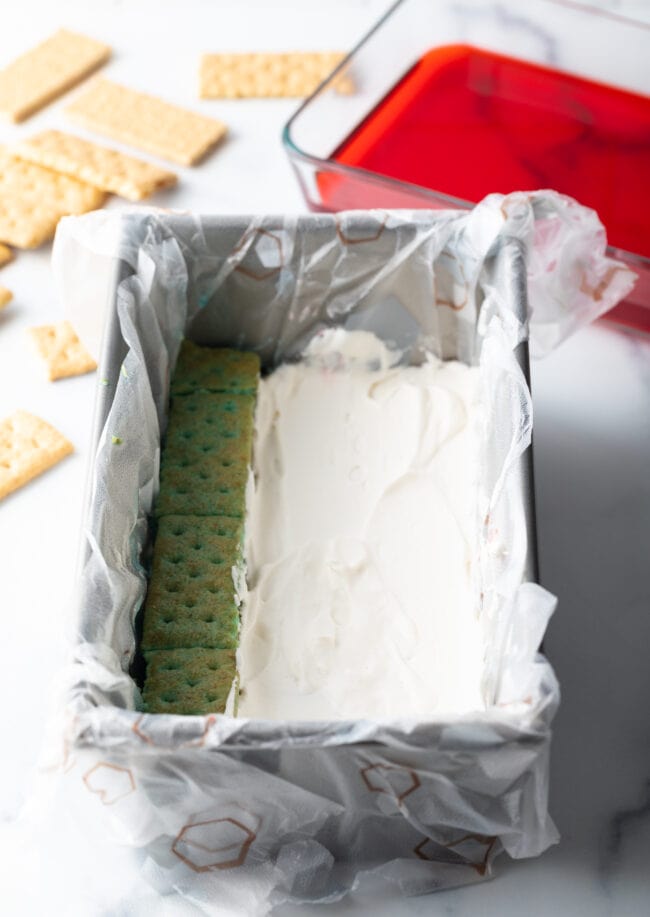 Adding a whipped cream layer to the cake pan.