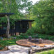 Milwaukee mid century modern landscape with elevated fire pit and black Acapulco chairs