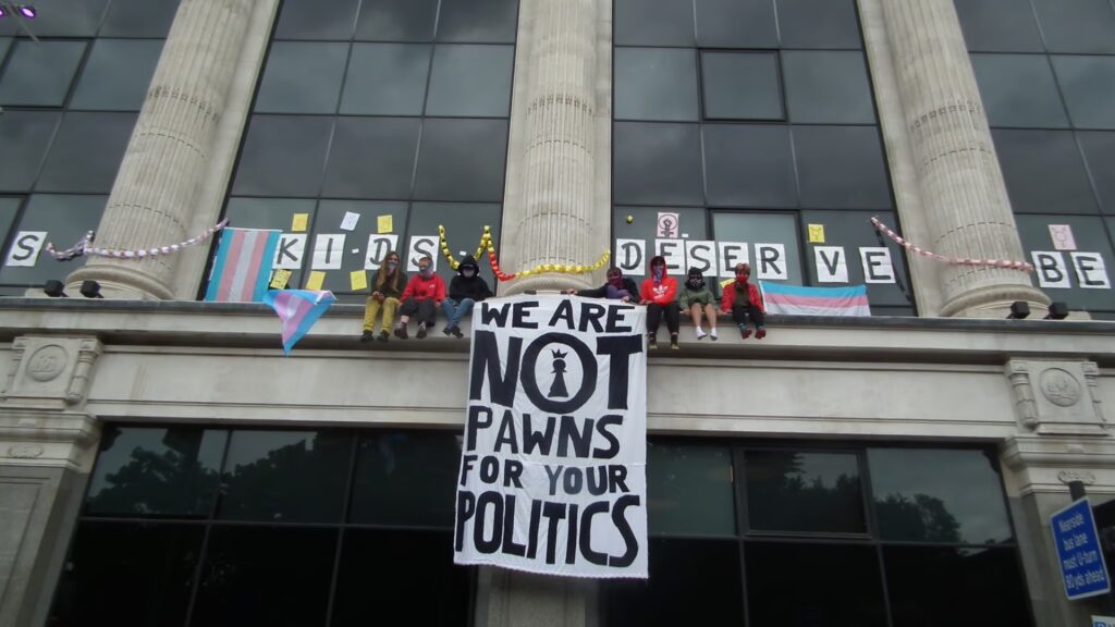 Teen trans activists scale NHS England London HQ as protest enters 3rd day