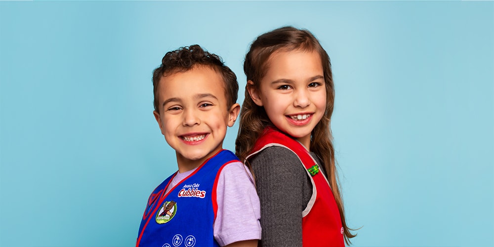 Awana Cubbie and Awana Sparkie stand side by side