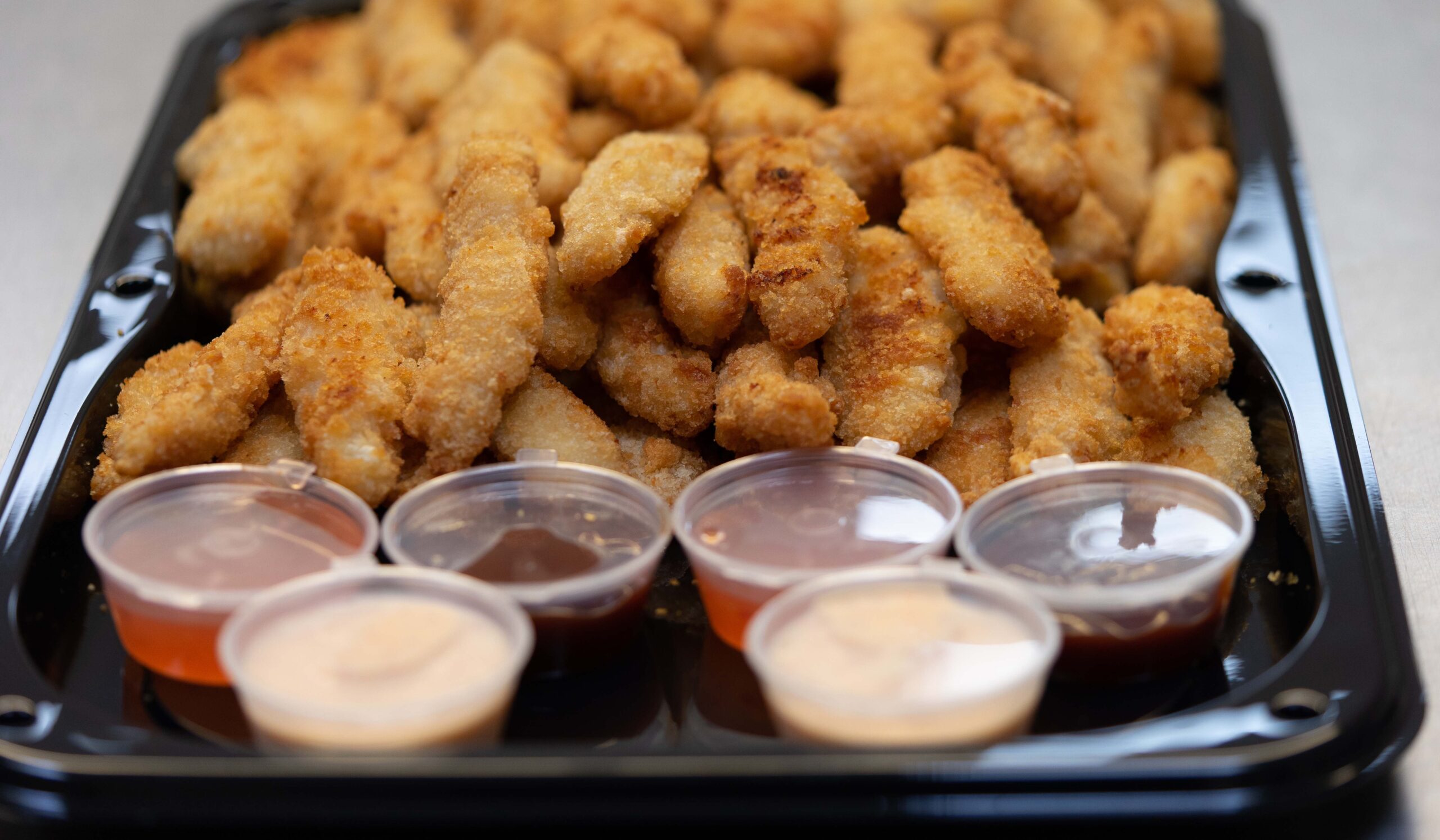 Portion of boneless chicken with dips