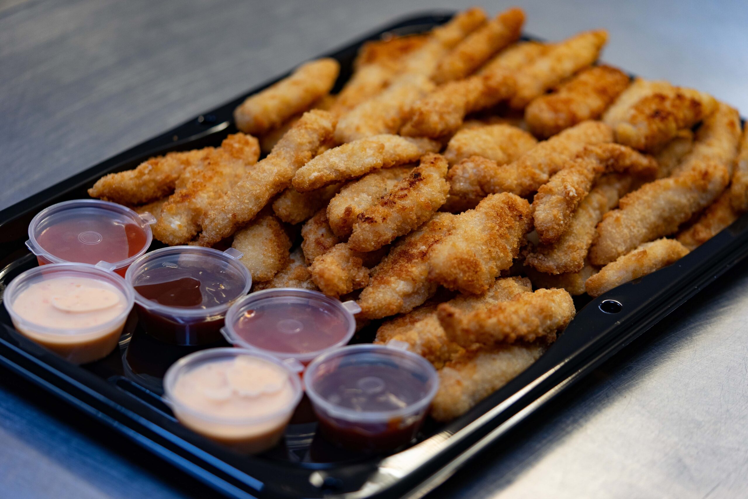 Portion of boneless chicken with dips