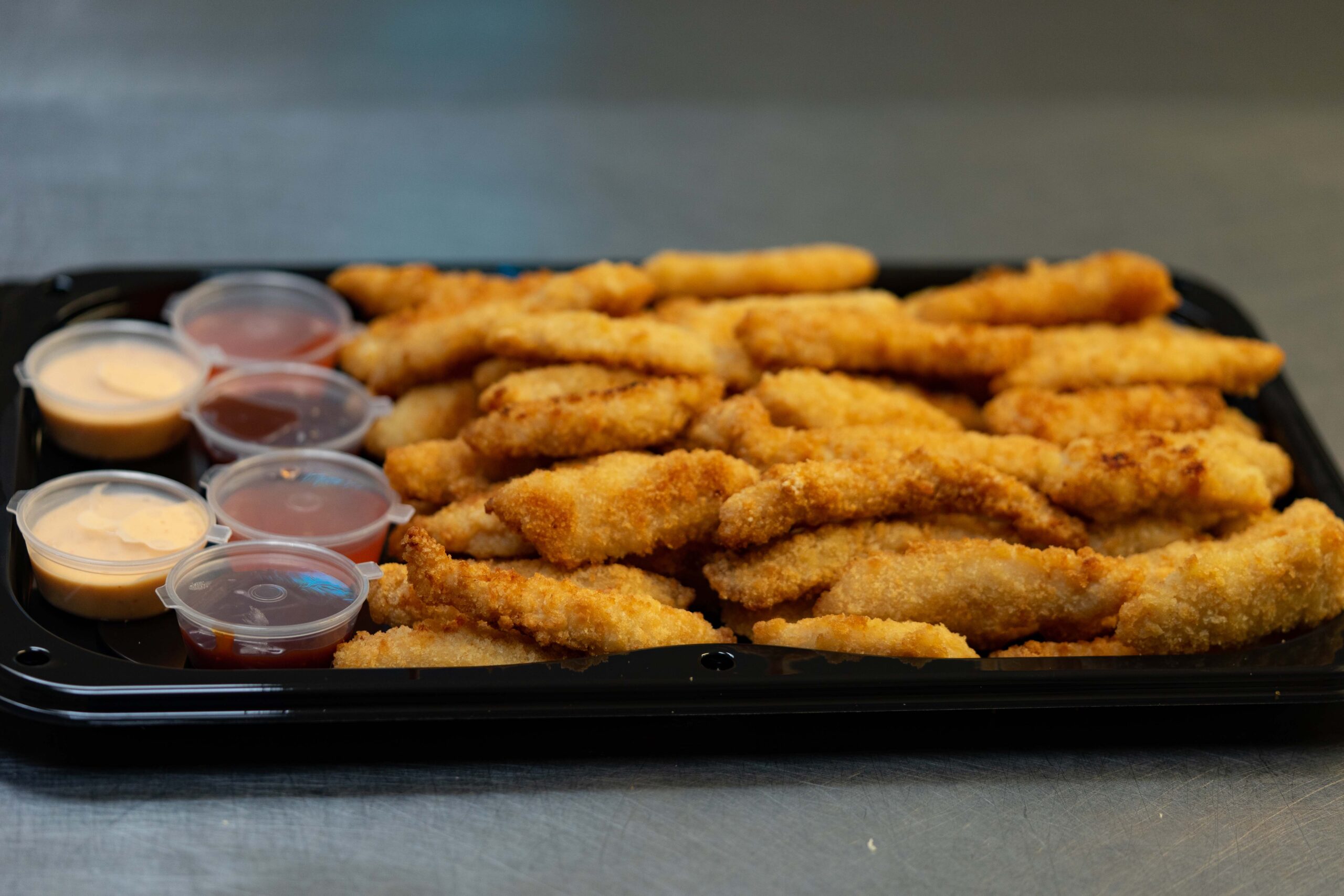 Portion of boneless chicken with dips