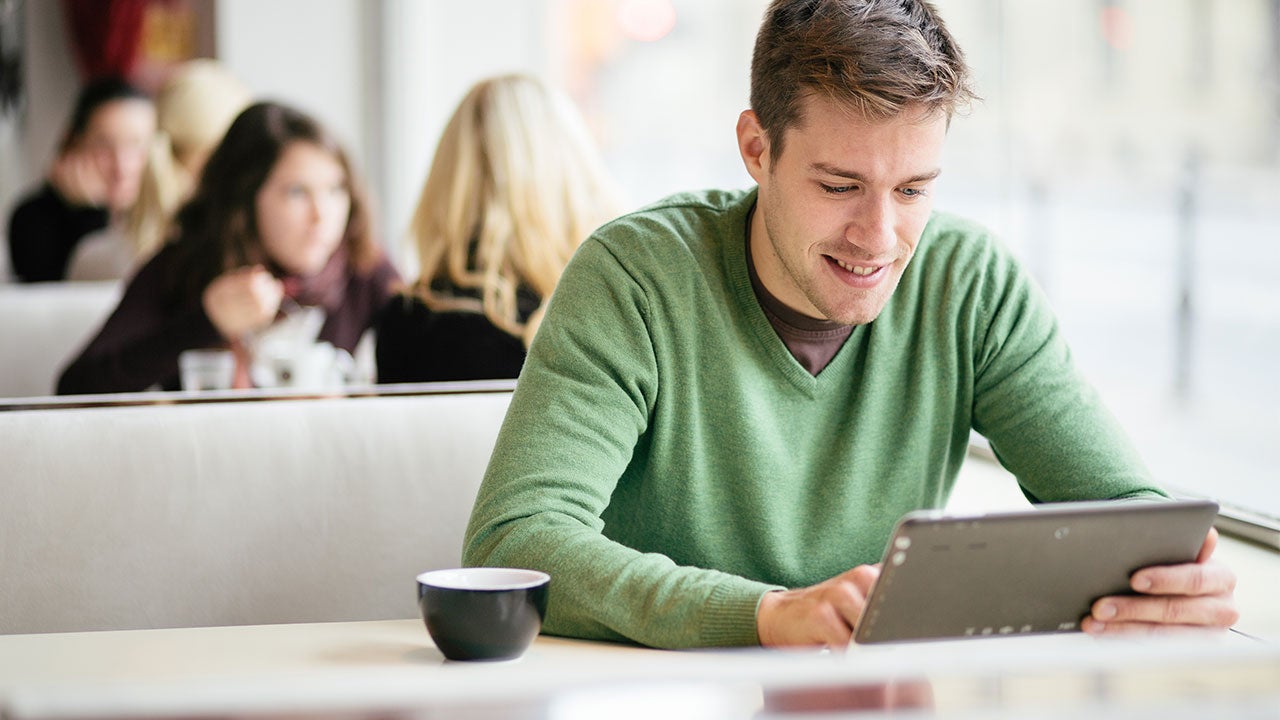 Man looking at loan on tablet