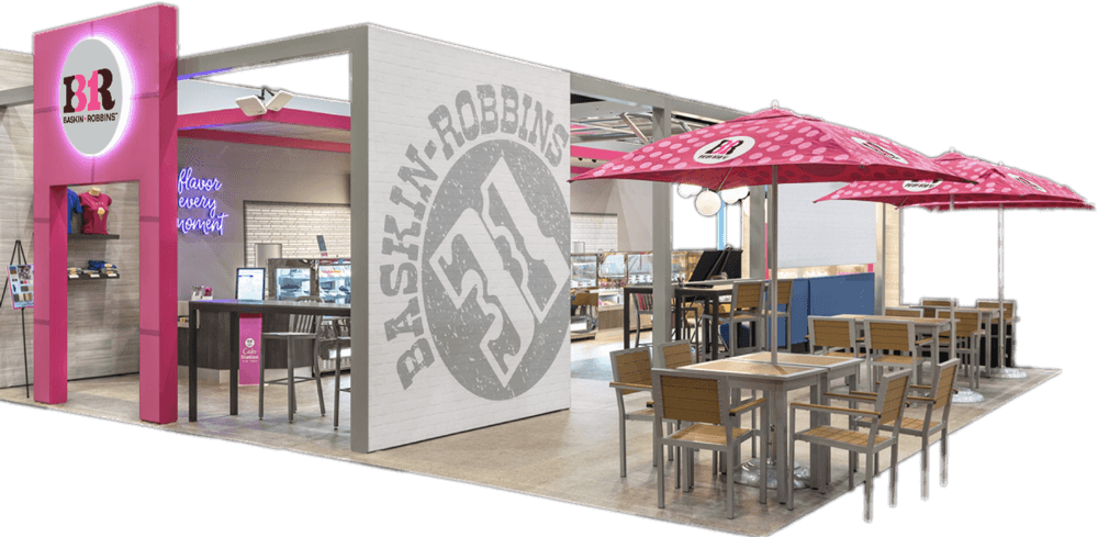 A modern Baskin-Robbins ice cream franchise with outdoor seating, featuring branded pink umbrellas.