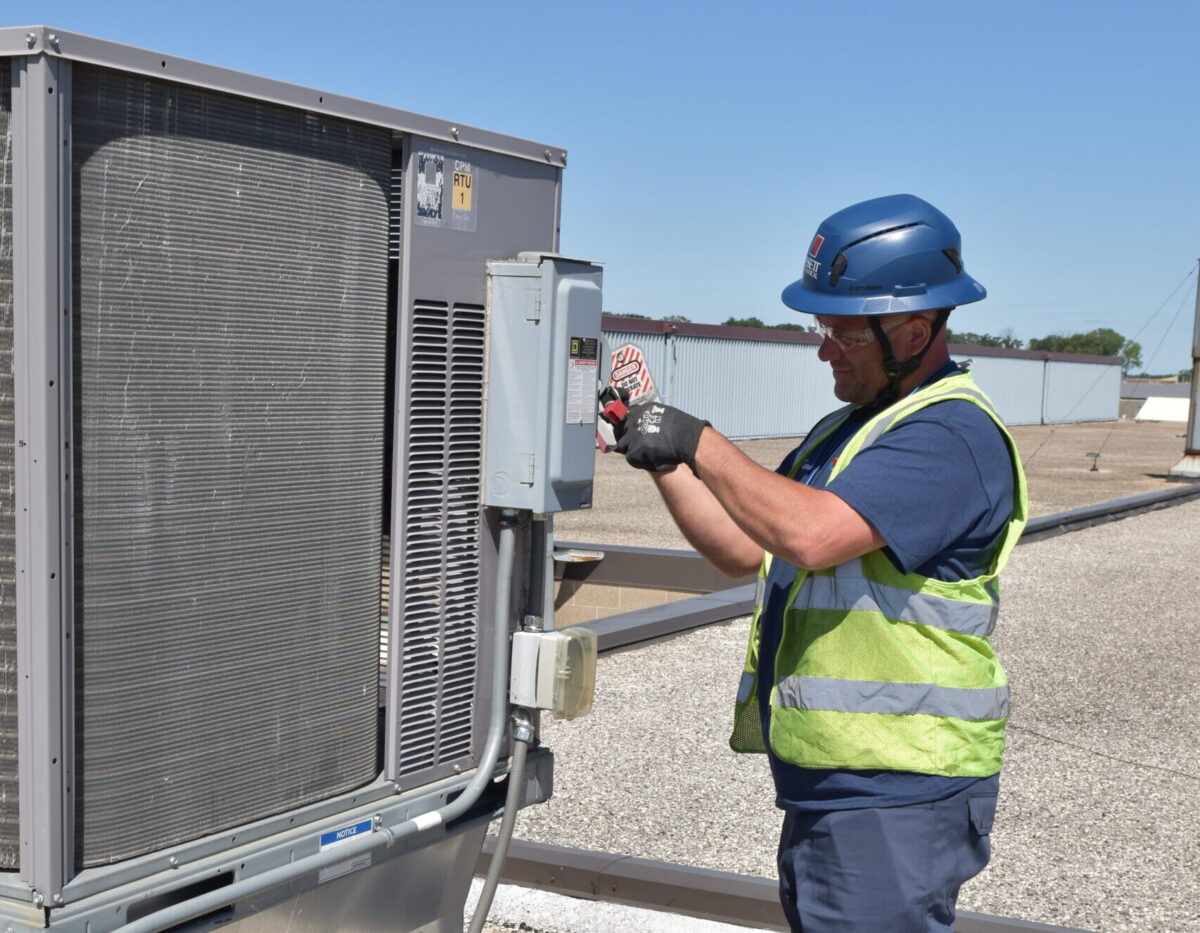 Bassett Mechanical HVAC Technician Working on Equipment