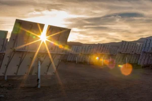 Sunset peeking through heliostats.