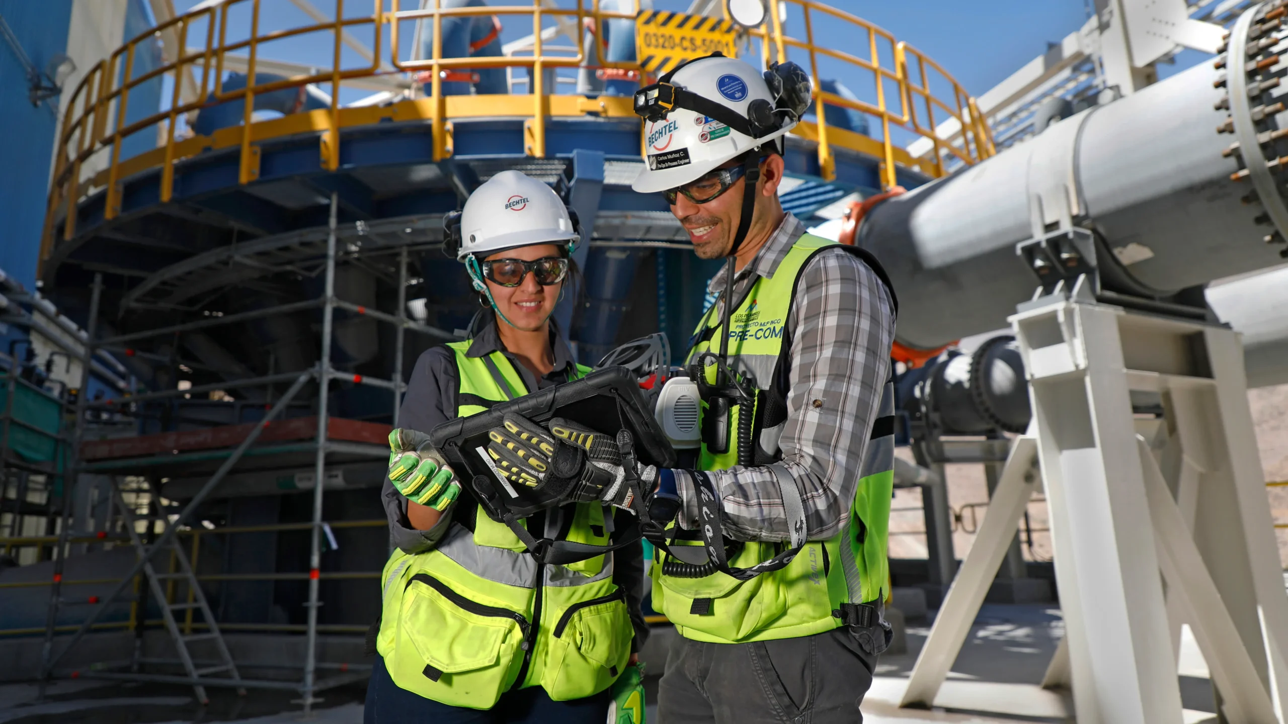 Two colleagues assess operations at jobsite. 