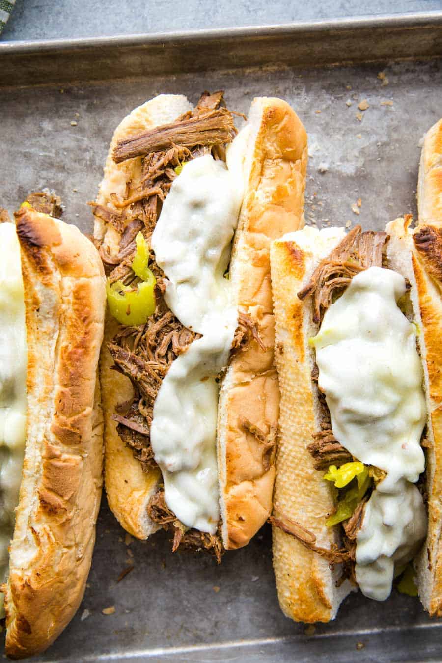 top view of Italian Beef Sandwiches topped with melted cheese