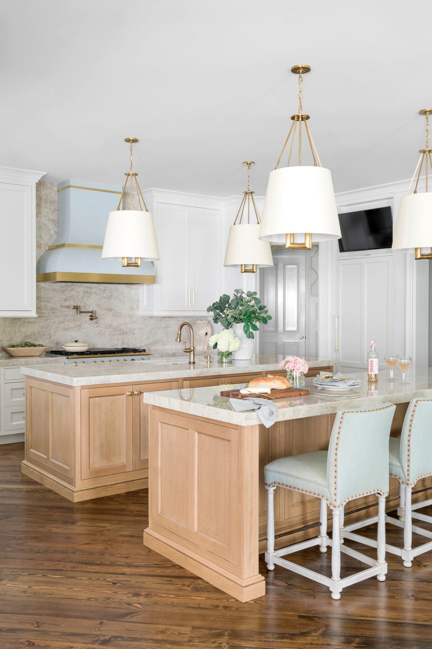 Kitchen Remodel Before and After with white sewn oak double islands and blue range.