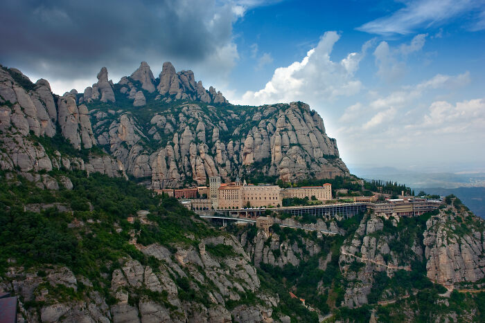 buildings on the background of mountains with trees