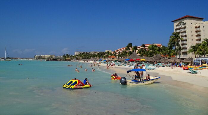 boats near the beach with a lot of people