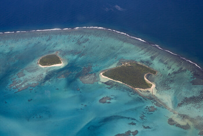 two small islands in the ocean seen from the flight