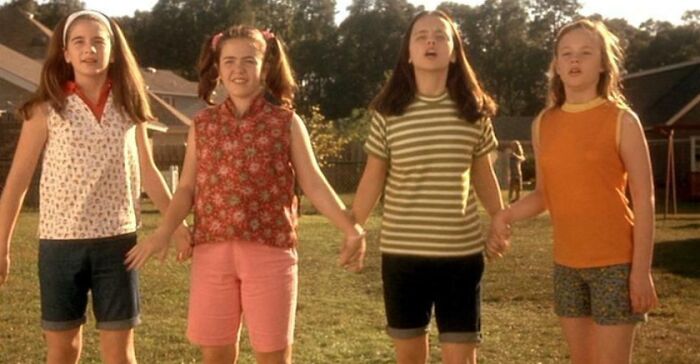 Four girls holding hands in a backyard, representing iconic best friend duos.