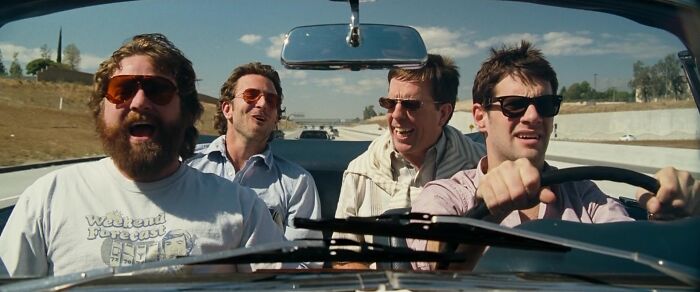 Four friends driving in a convertible car, enjoying a road trip, embodying iconic best friend duos and friendship.