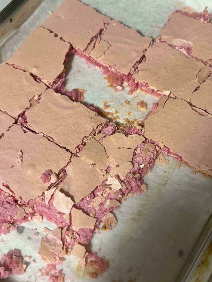 Cracked pink dessert squares with uneven pieces arranged messily on a tray, highlighting lazy-infuriating-people.