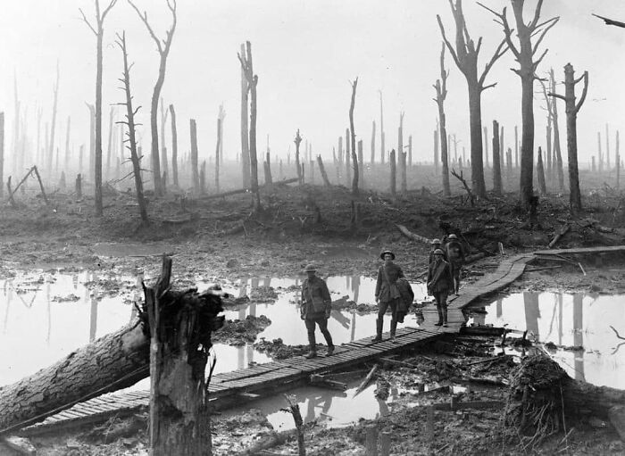 Soldiers crossing a wooden path in a war-torn landscape, illustrating how we learn from the past.