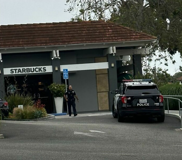 Police SUV parked in a handicapped spot at Starbucks, showcasing lazy-infuriating-people behavior.